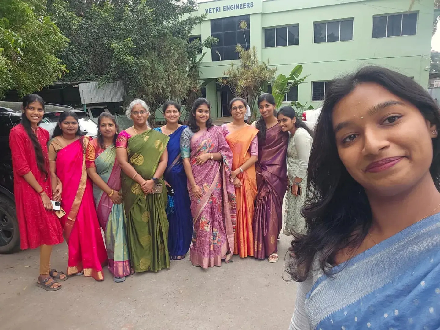 Team members in traditional attire at an office celebration