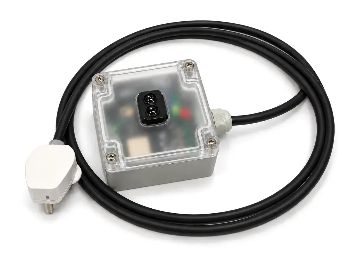 GT Sense: a compact grey enclosure with a clear lid and a laser distance sensor, with its mains cable and plug
