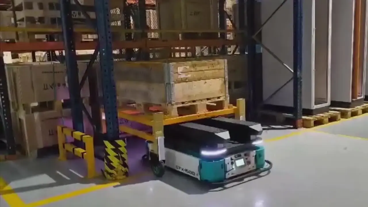 GOAT GTX heavy-duty AMR moving a pallet past warehouse racking